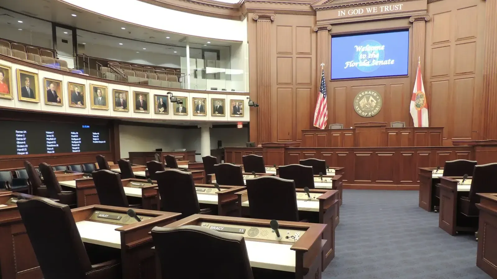 The Florida State Capitol in Tallahassee, the modern tower rising behind the dome of the historic capitol, with state flags and the state seal in the foreground, photographed 27 June 2022. Photo by Riis2602, CC BY-SA 4.0, via Wikimedia Commons.