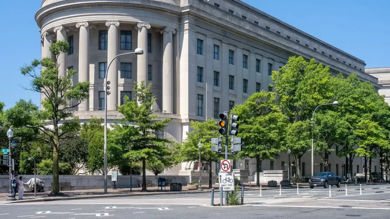 The Federal Trade Commission headquarters, the Apex Building, in Washington, D.C., a curved limestone facade with columns and the words Federal Trade Commission over the entrance, photographed 21 June 2024. Photo by Ajay Suresh, CC BY 2.0, via Wikimedia Commons.