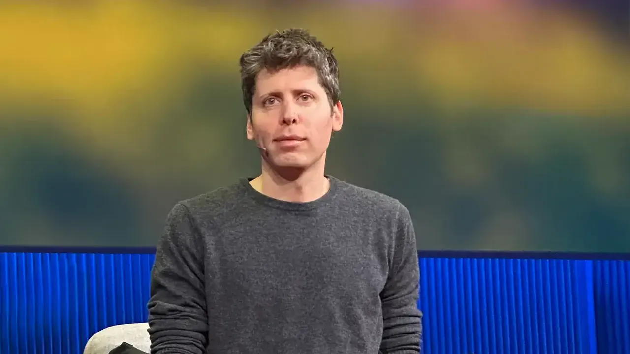 Sam Altman speaking at TED on 11 April 2025, in a dark sweater against a red backdrop with the TED logo. Photo by Steve Jurvetson, CC BY 2.0, via Wikimedia Commons.