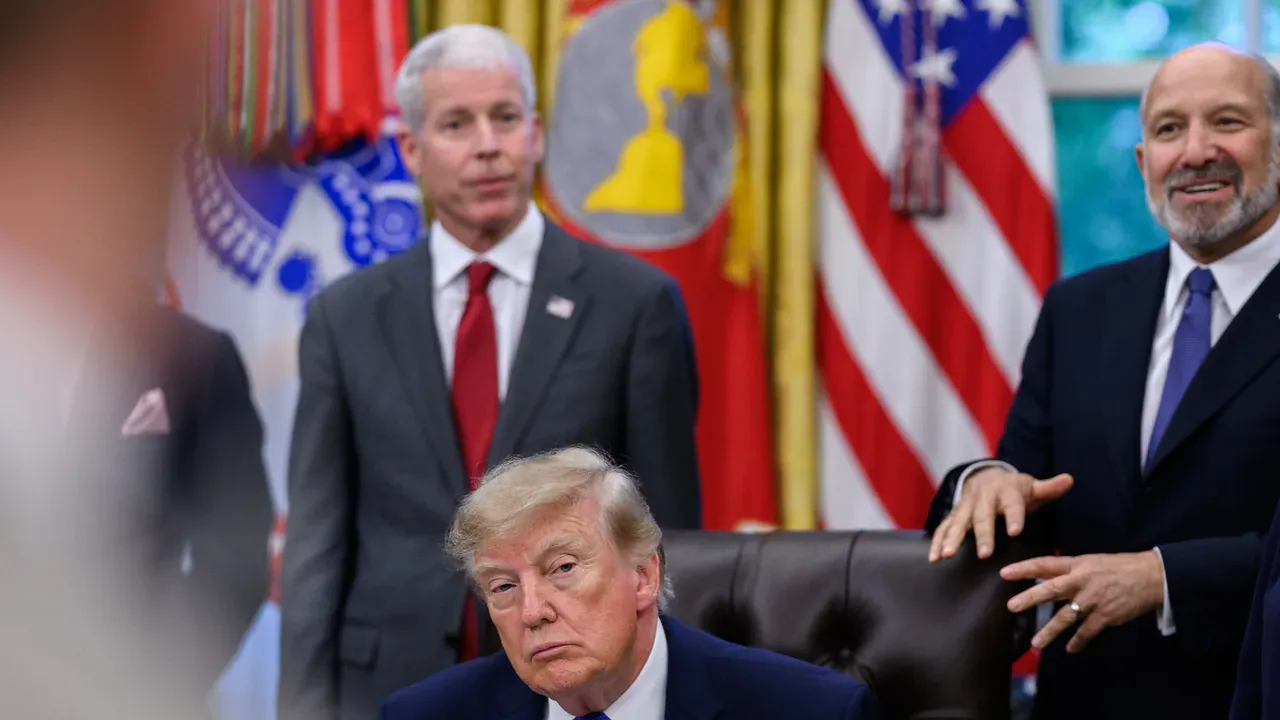 President Donald J. Trump seated at the Resolute Desk in the Oval Office on 28 September 2026, during an announcement on steel. He wears a dark suit and red tie, with the presidential flag and the American flag behind him and a steel-industry sign in the foreground. The lead image is a 1280 by 720 WebP cropped from the top of the Commons photograph. Official White House photo by Molly Riley, public domain, via Wikimedia Commons.